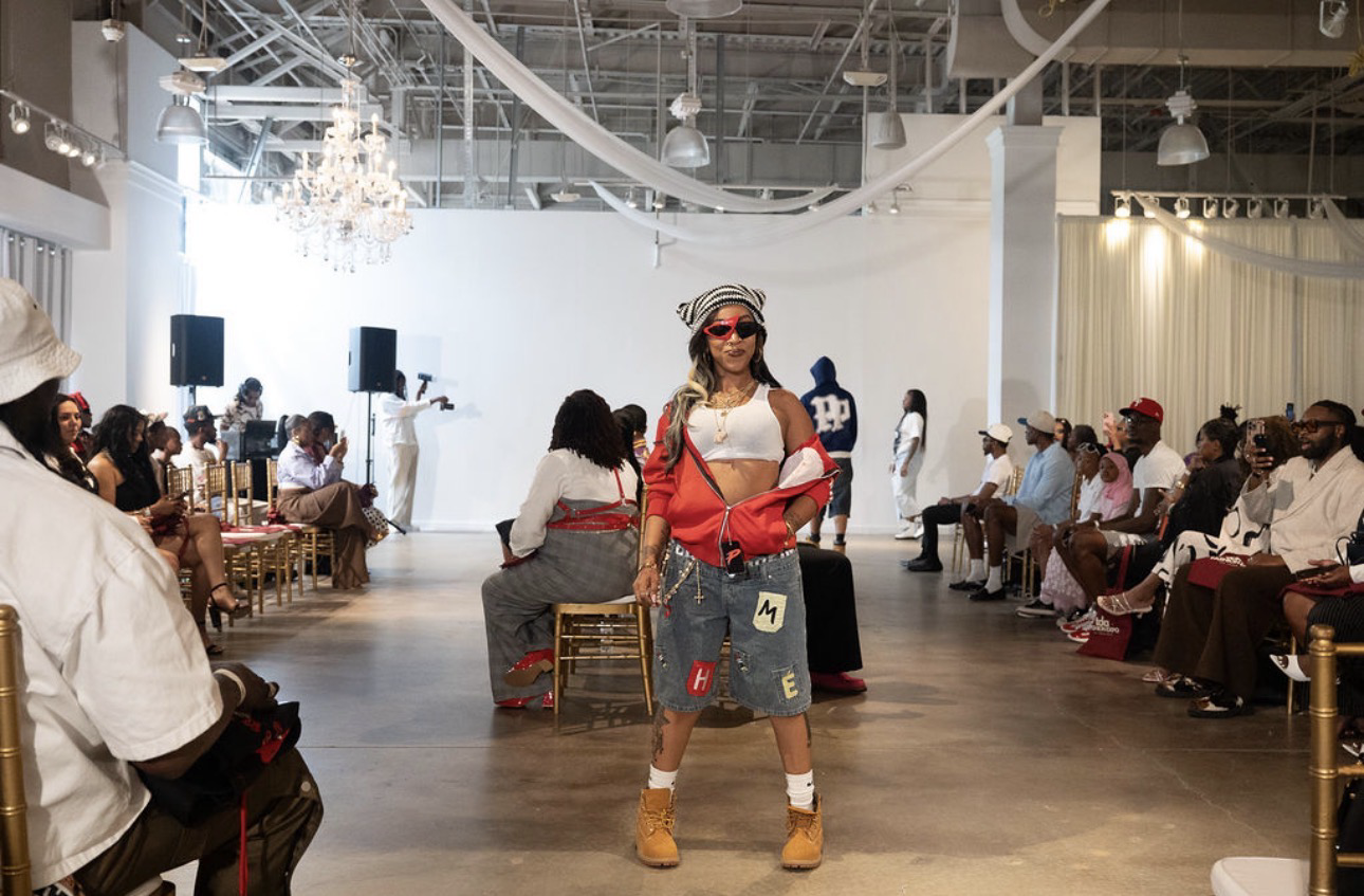 TDA Fashion Expo runway model in a red jacket and denim shorts