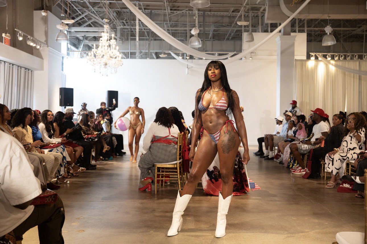 TDA Fashion Expo runway model in a flag-print bikini and white boots